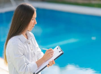 Woman conducting a Pool Inspection with Clipboard