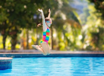 Girl Jumping into Swimming Pool