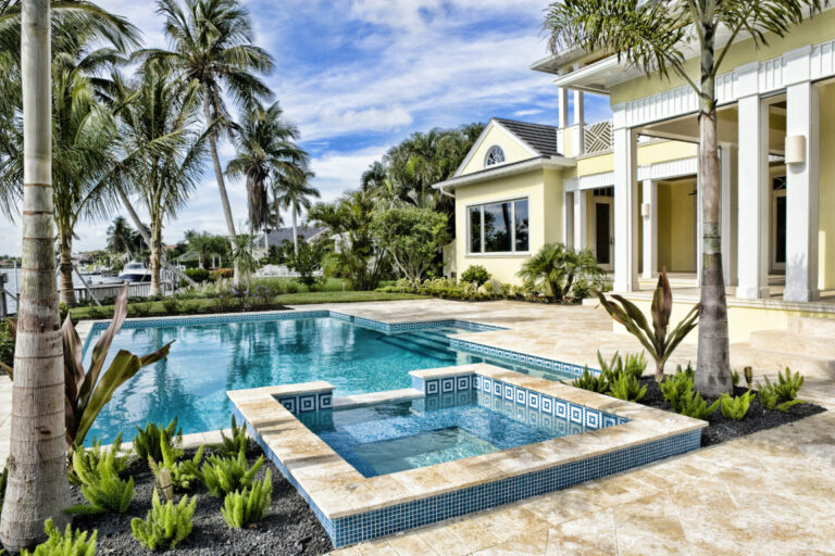 Rectangular Pool & Spa surrounded by travertine tiles Pensacola FL