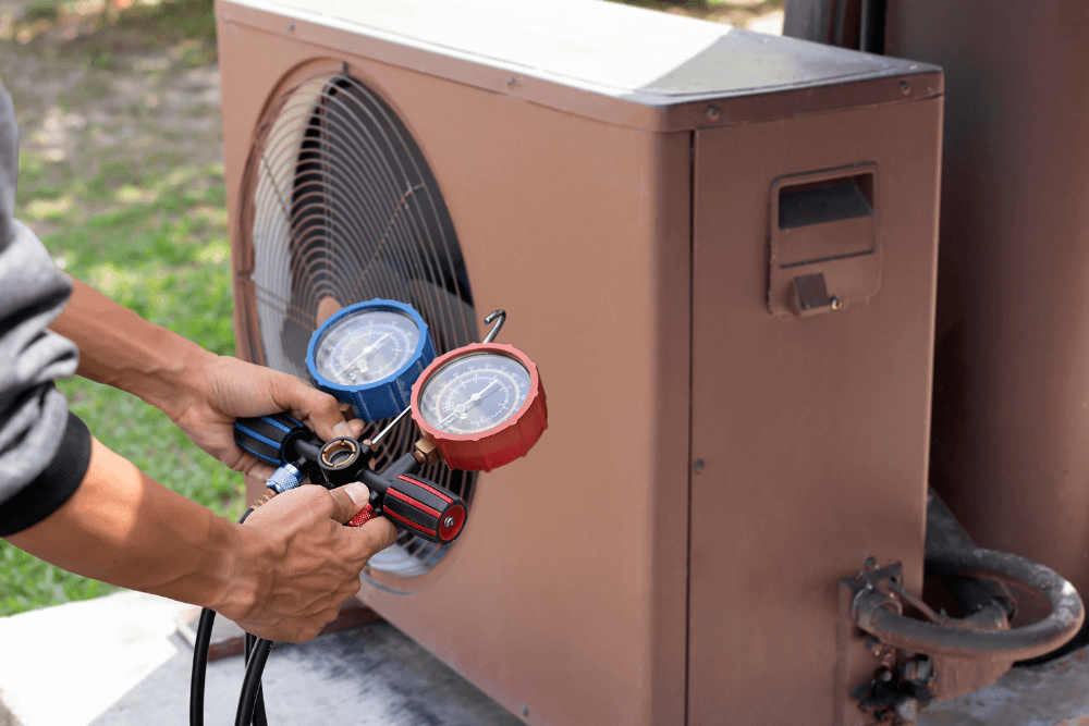 man checking the pressure gauge for a pool heater