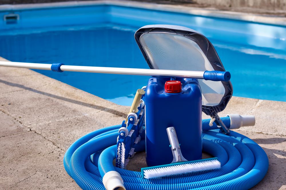 ool equipment with cleaning chemicals and tools on the pool curb during a pool inspection.